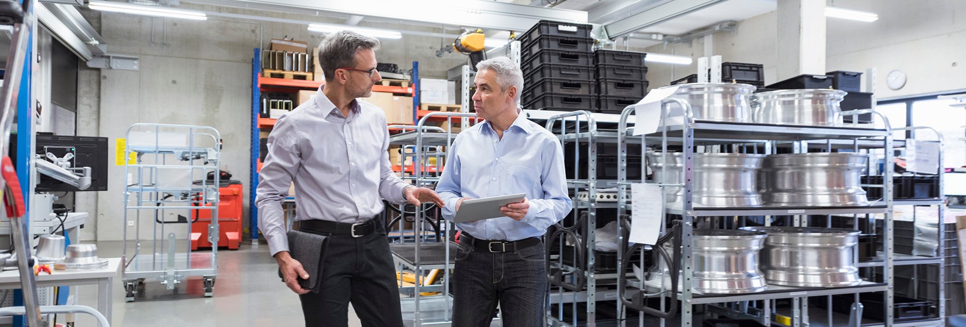 Two men discussing operations on the production floor.