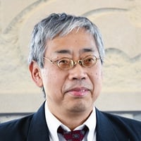 Headshot of George Yang, wearing a dark suit and maroon tie.
